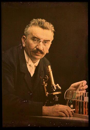 Louis Lumiere with microscope and test tubes Focus