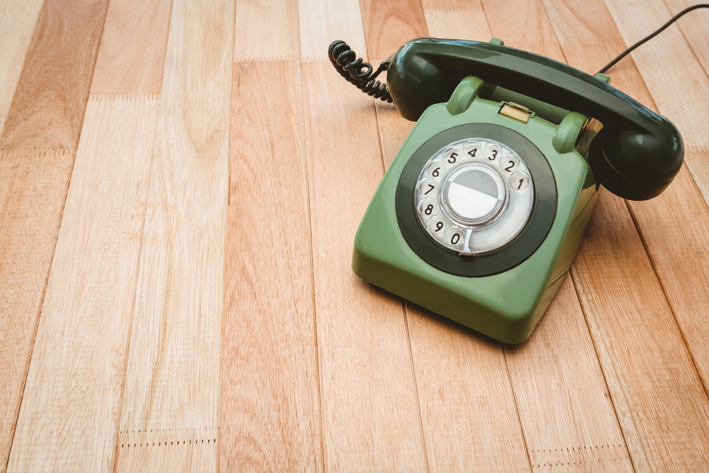 View of an old phone on wood desk.jpeg